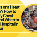 Patient holding chest pain in Mumbai hospital emergency room while cardiologist examines, showing confusion between gas and heart attack symptoms